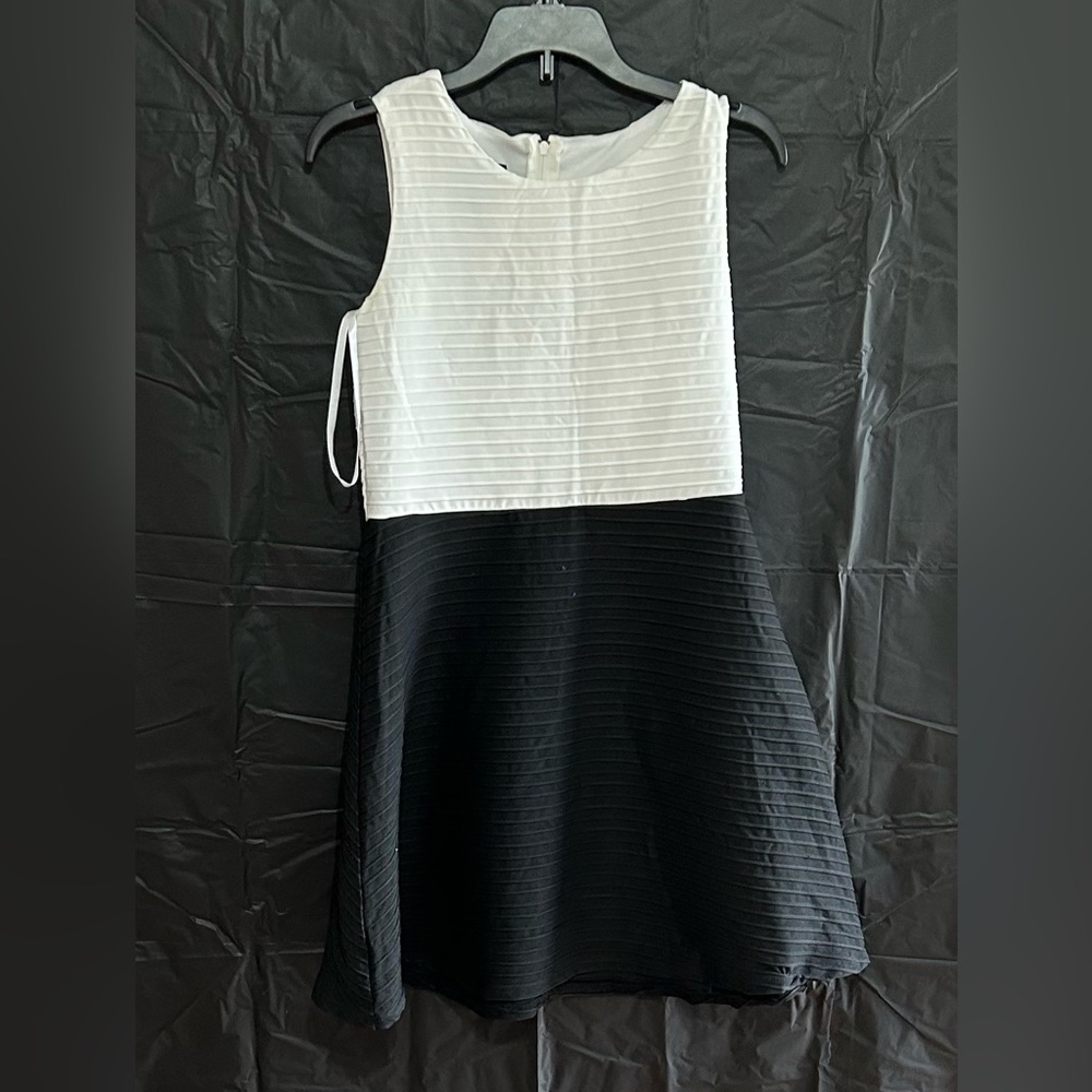 It’s a beautiful By&By black and white dress in a youth 14
